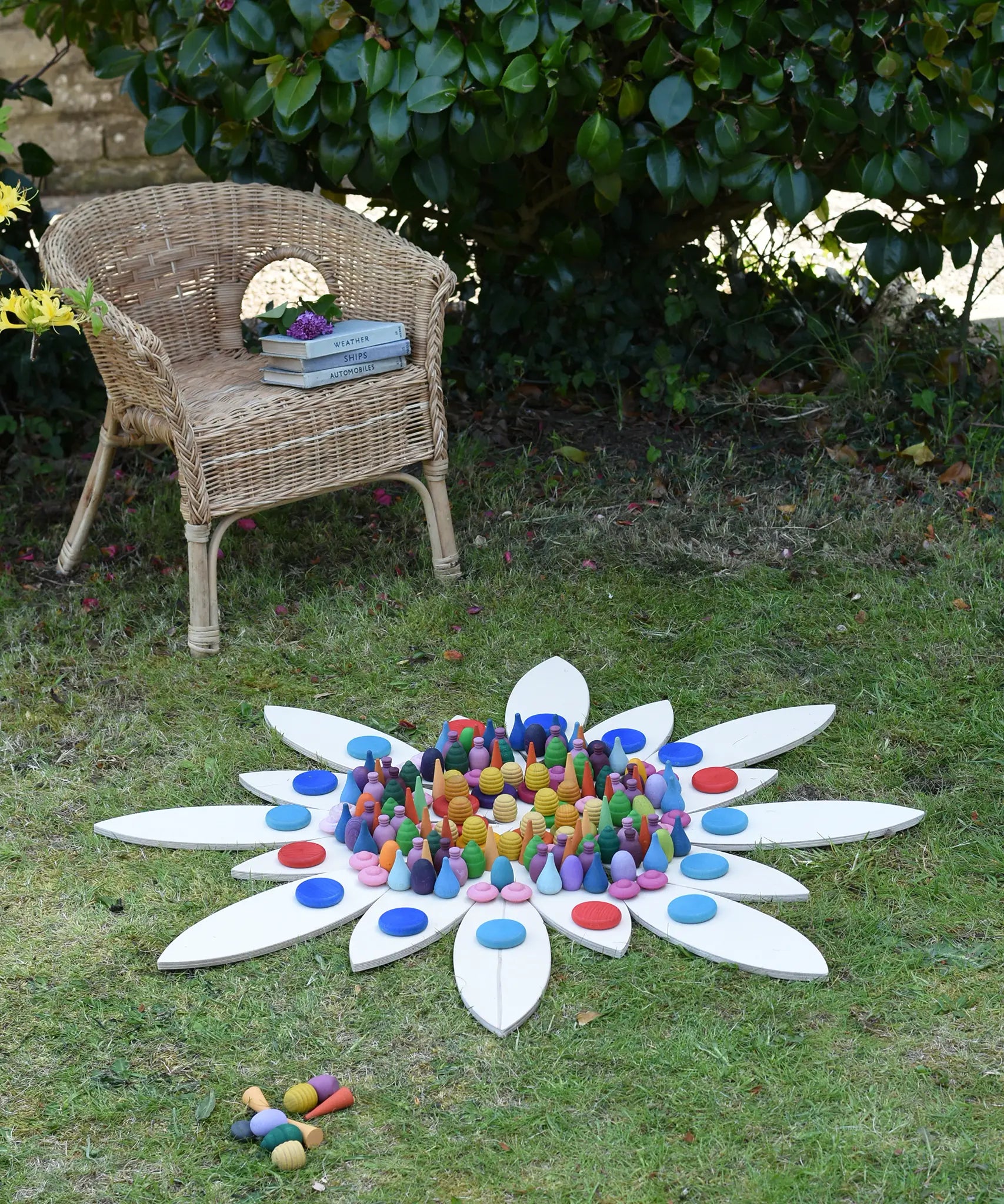 Grapat petal platform pieces laid out on grass to create a mandala with Grapat lose parts.