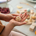 Close up of a childs hands holding a piece from the Grapat eco-friendly wild wonders toy set