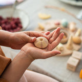 Close up of a childs hands holding a piece from the Grapat eco-friendly wild wonders toy set