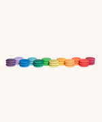 Grapat Loose Parts Rainbow Coins 12 Colours in a pack of 36 wooden coins with 3 of each of the 12 colours. Grapat have a wide range of wooden loose parts and toys available at Babipur. 