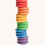 Grapat Loose Parts Rainbow Coins 6 Colours Supplementary Set in a pack of 18. The coins have all been stacked on top of each other. Grapat have a wide range of wooden loose parts and toys available at Babipur. 
