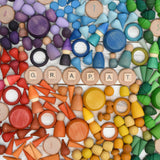 A variety of coloured handcrafted Grapat wooden loose pieces laid in a decorative flatlay