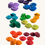 Grapat Rainbow Mandala Flowers. A set of 36 wooden pieces in rainbow colours, there are 3 in each colour. These wooden toys are part of a large range of loose parts available at Babipur. 