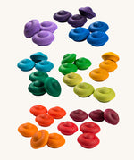 Grapat Rainbow Mandala Flowers. A set of 36 wooden pieces in rainbow colours, there are 3 in each colour. These wooden toys are part of a large range of loose parts available at Babipur. 