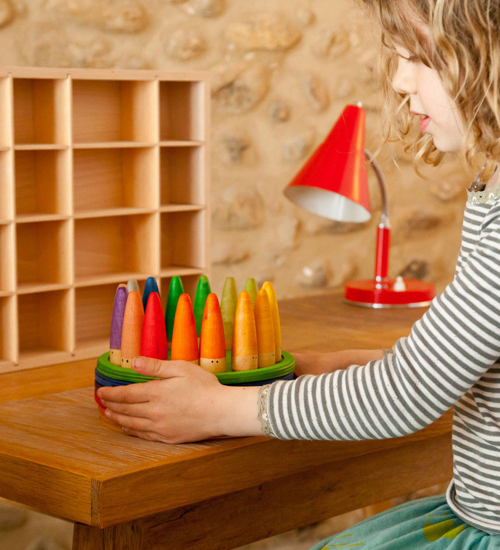 A child playing with the Grapat 18 Palos Stick Men Wooden Peg Dolls. These wooden toys are part of a wide range of open ended toys available at Babipur.  