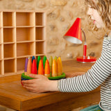 A child playing with the Grapat 18 Palos Stick Men Wooden Peg Dolls. These wooden toys are part of a wide range of open ended toys available at Babipur.  