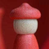 Handcrafted Grapat wooden peg doll in with a red body and matching hat from the 7 moons calendar set