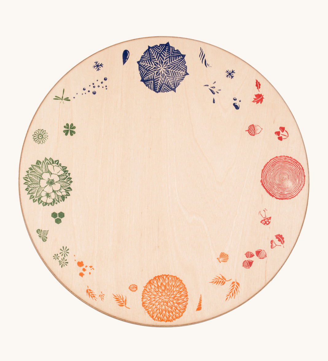 Grapat 4 Seasons and Elements Play Platform. A wooden circle shaped platform and stamped with elements and details to represent the four season. These handcrafted items from Grapat are part of a wide range of wooden toys available here at Babipur.