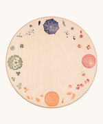 Grapat 4 Seasons and Elements Play Platform. A wooden circle shaped platform and stamped with elements and details to represent the four season. These handcrafted items from Grapat are part of a wide range of wooden toys available here at Babipur.