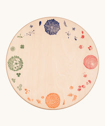 Grapat 4 Seasons and Elements Play Platform. A wooden circle shaped platform and stamped with elements and details to represent the four season. These handcrafted items from Grapat are part of a wide range of wooden toys available here at Babipur.