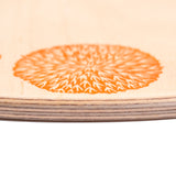 A close up of the orange details on the Grapat 4 Seasons and Elements Play Platform. A wooden circle shaped platform and stamped with elements and details to represent the four season. These handcrafted items from Grapat are part of a wide range of wooden toys available here at Babipur.