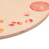 A close up of the red details on the Grapat 4 Seasons and Elements Play Platform. A wooden circle shaped platform and stamped with elements and details to represent the four season. These handcrafted items from Grapat are part of a wide range of wooden toys available here at Babipur.