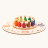 The Grapat Perpetual calendar set placed on the Grapat 4 Seasons and Elements Play Platform. A wooden circle shaped platform and stamped with elements and details to represent the four season. These handcrafted items from Grapat are part of a wide range of wooden toys available here at Babipur.