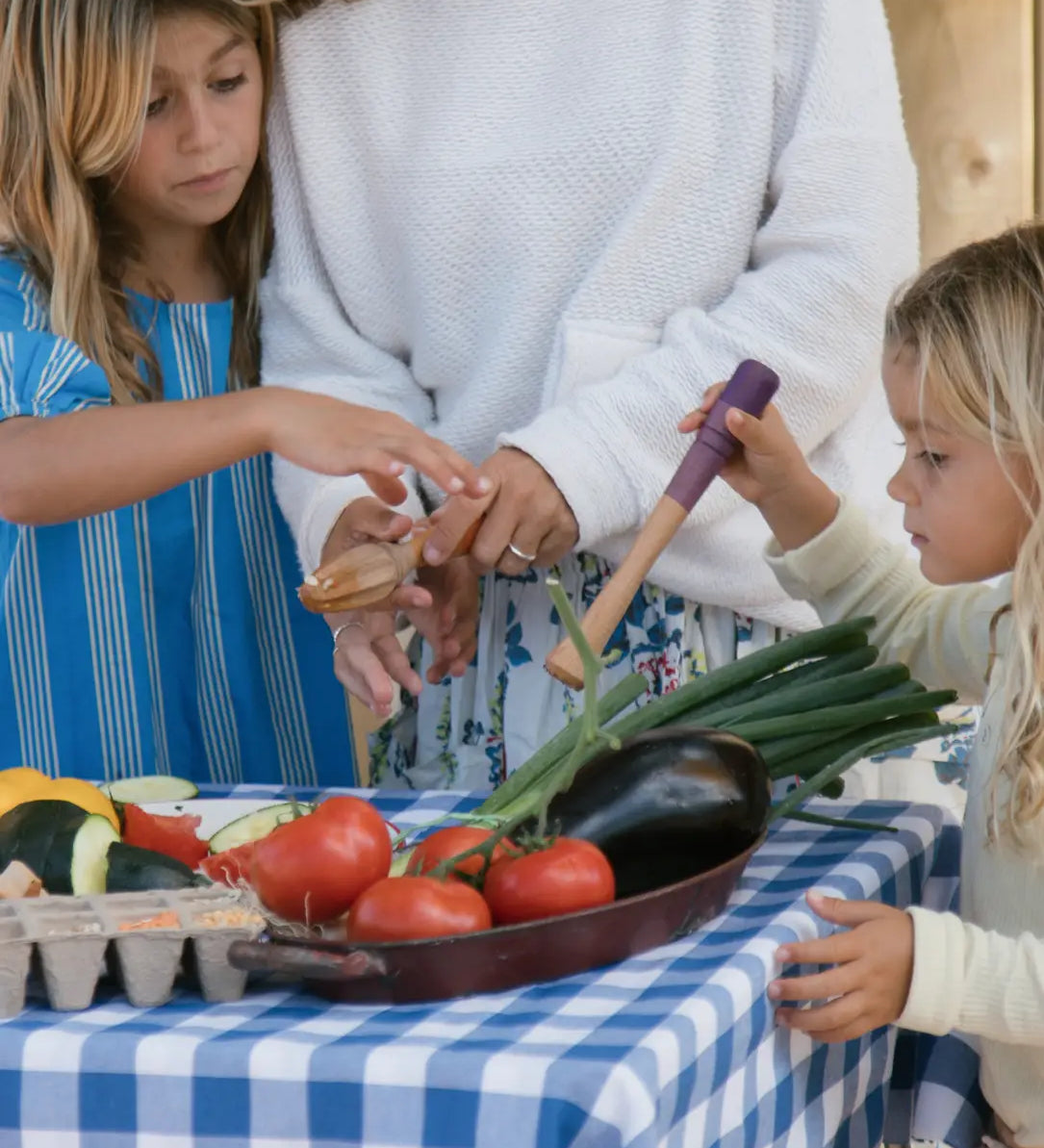 Children playing with Grapat wooden sensory play tools and vegetables.