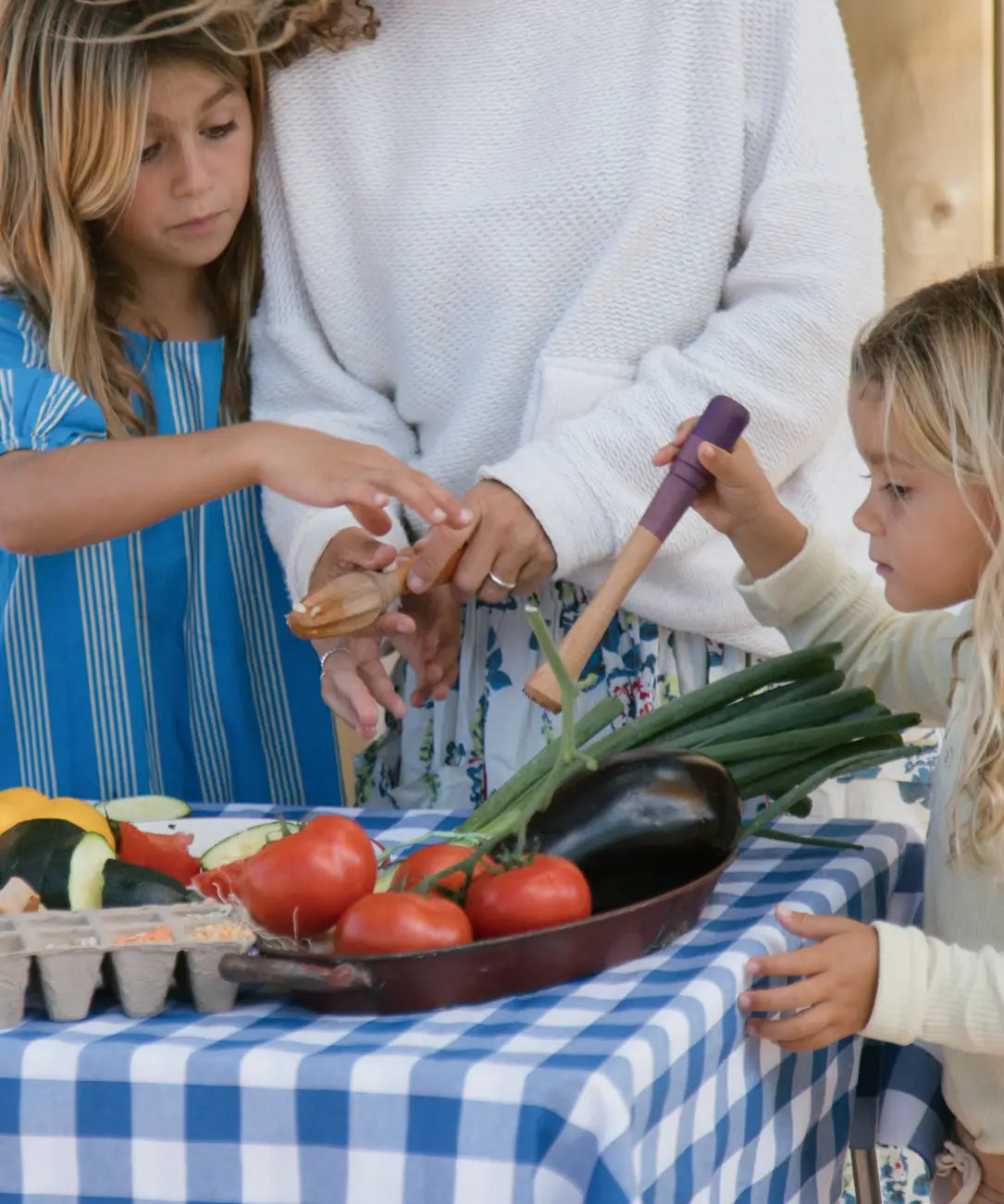 Children playing with Grapat wooden sensory play tools and vegetables.
