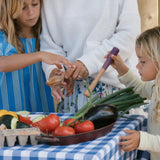 Children playing with Grapat wooden sensory play tools and vegetables.