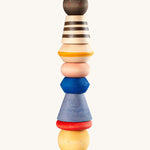 Grapat serendipity wooden stacking set - A vibrant wooden stacking set which features 8 different handcrafted wooden shaped pieces stacked. Features a brown, light pink, blue yellow orange and striped pieces. 
