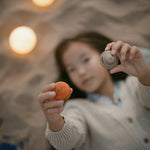 a child is gazing at one of the small planets
