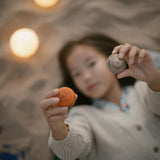 a child is gazing at one of the small planets