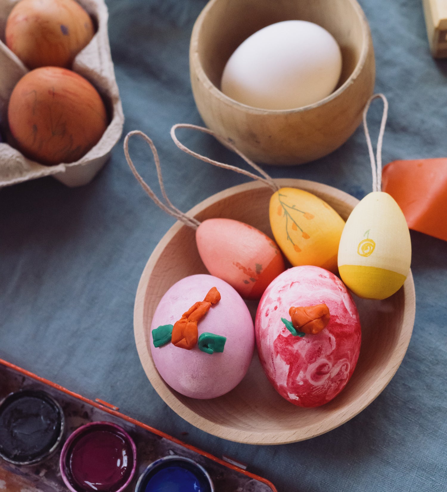 Grapat Handmade Sunrise Eggs Wooden Easter Decorations. The 3 eggs are in a little wooden dish along side real eggs that have been painted.