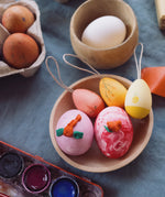 Grapat Handmade Sunrise Eggs Wooden Easter Decorations. The 3 eggs are in a little wooden dish along side real eggs that have been painted.