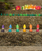 The Grapat set of 6 Rainbow Tomten Figures placed on a step outdoors. Grapat have a wide range of open ended wooden toys and loose parts available at Babipur. 