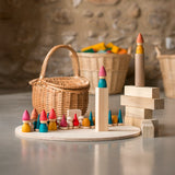 Grapat Tomten Nins wooden peg dolls and loose parts play set placed on a wooden base and blocks. 