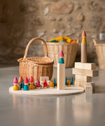 Grapat Tomten Nins wooden peg dolls and loose parts play set placed on a wooden base and blocks. 