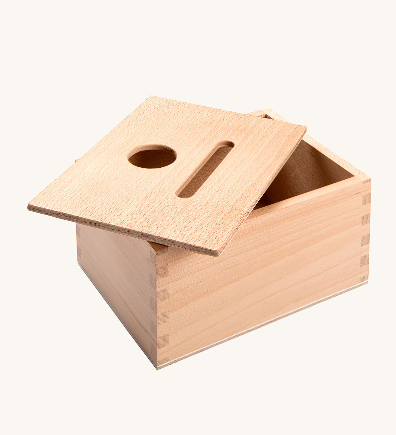 Grapat Permanence Box. A wooden box that has two slots in the top one for coins and one circular that will fit small toys such as Nin peg dolls. This wooden box is part of a wide range of open ended toys available at Babipur. 