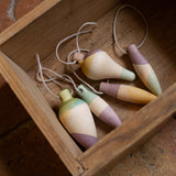 Multicoloured wooden Grapat twinkle decorations in a wooden box