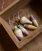 Multicoloured wooden Grapat twinkle decorations in a wooden box