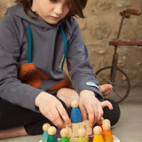 Grapat English Perpetual Calendar displaying the 12 nin peg dolls in colours representing the months of the year according to Waldorf teachings. The display ring has each month written in English around the edge and two cubes in the centre to mark the day