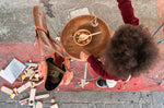 Close up of child playing with the Grapat yummy Waldorf play food next to a metal pot of grapes