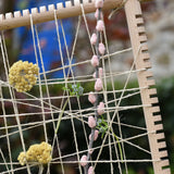 Close up of natural materials placed into the Grapat weaving frame.