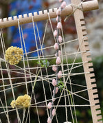 Close up of natural materials placed into the Grapat weaving frame.