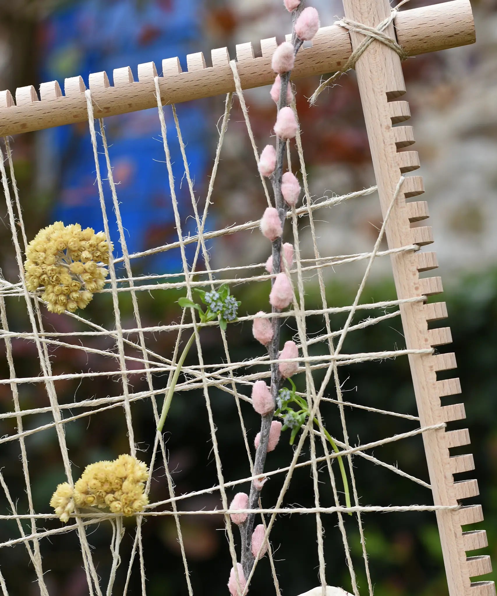 Close up of natural materials placed into the Grapat weaving frame.