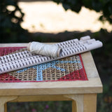 Grapat weaving frame parts placed on a stool outdoors.