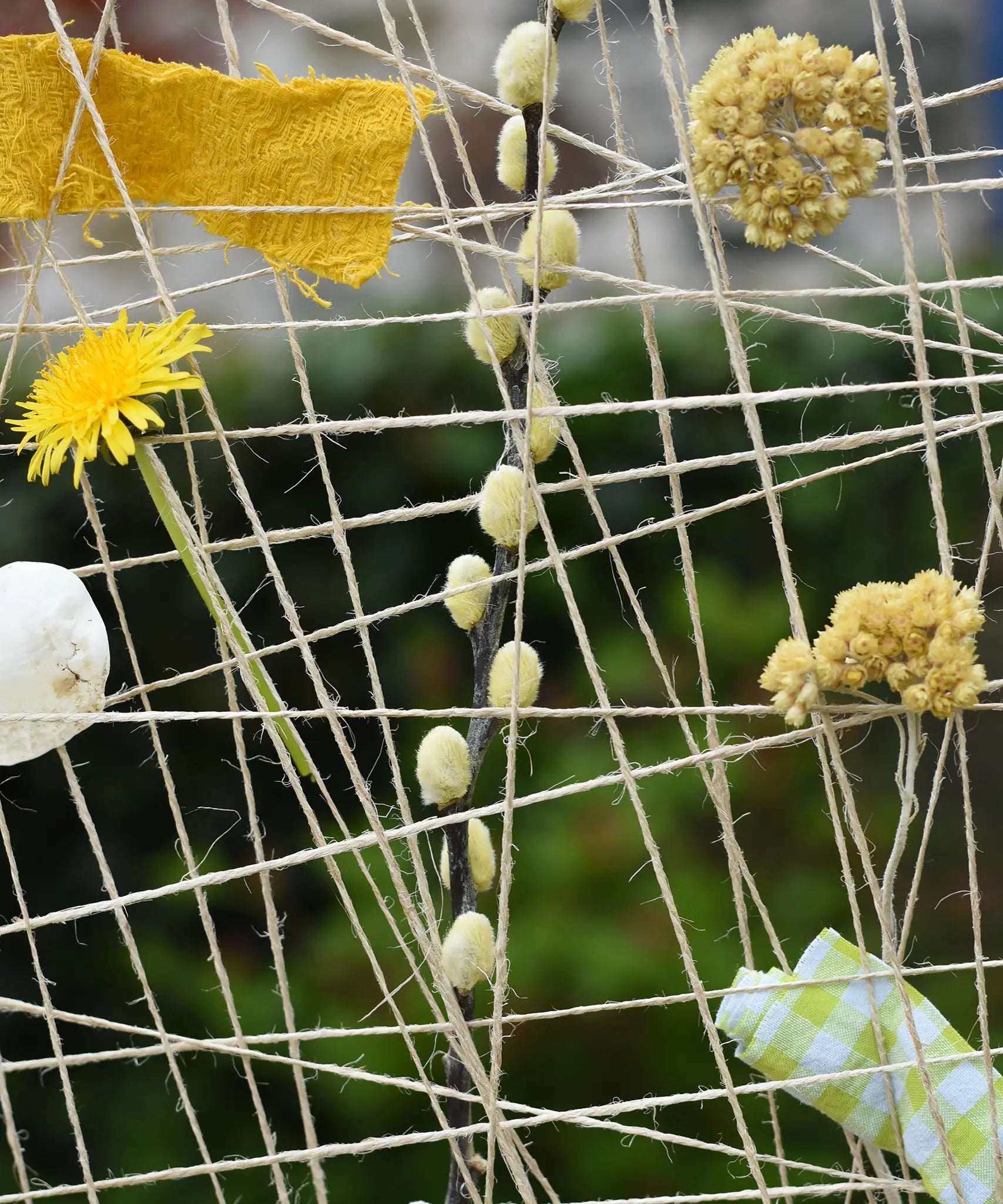 Close up of natural materials placed into the Grapat weaving frame.
