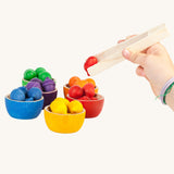 Grapat Wooden Toy Bowls and  Acorns Set. A set of 6 coloured bowls with wooden acorn shapes in matching pieces and wooden tongs. These wooden toys are part of a wide range of open ended toys available at Babipur.  
