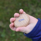 Grapat number 8 wooden counting coin in a child's hand. 