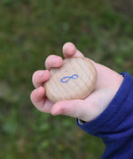 Grapat number 8 wooden counting coin in a child's hand. 