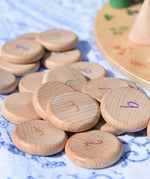 Grapat wooden counting number coins. Natural wooden coins with numbers drawn on. 