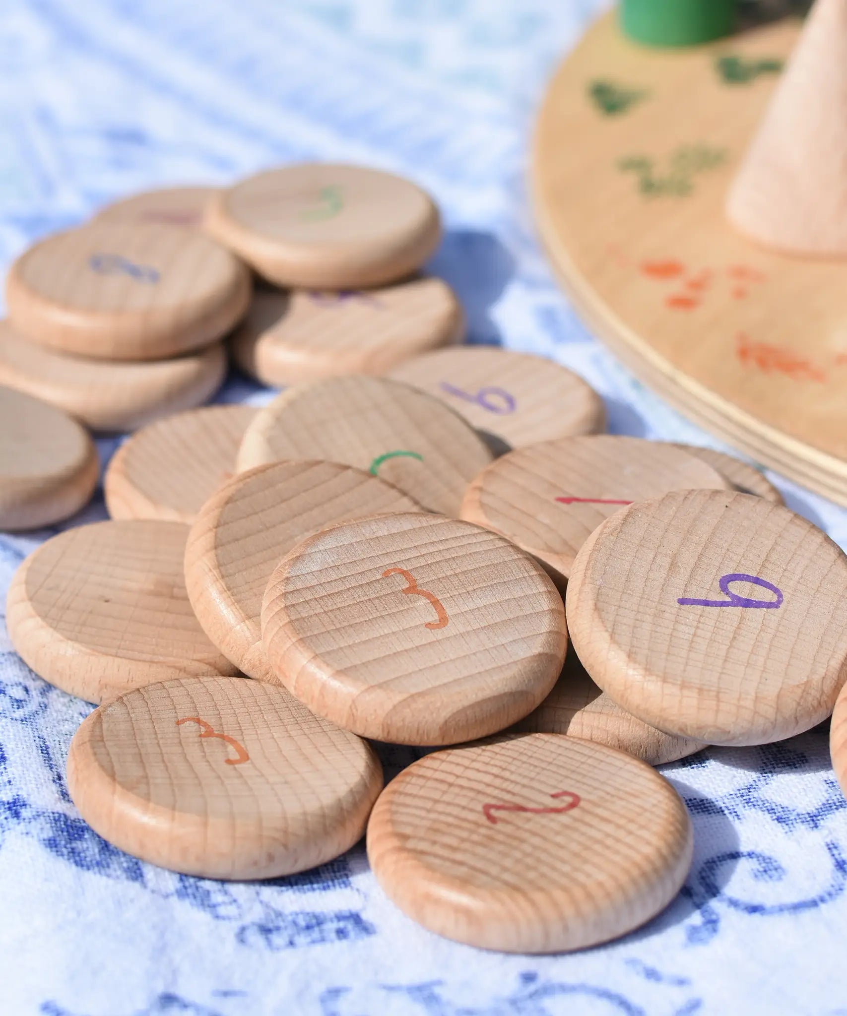 Grapat wooden counting number coins. Natural wooden coins with numbers drawn on. 