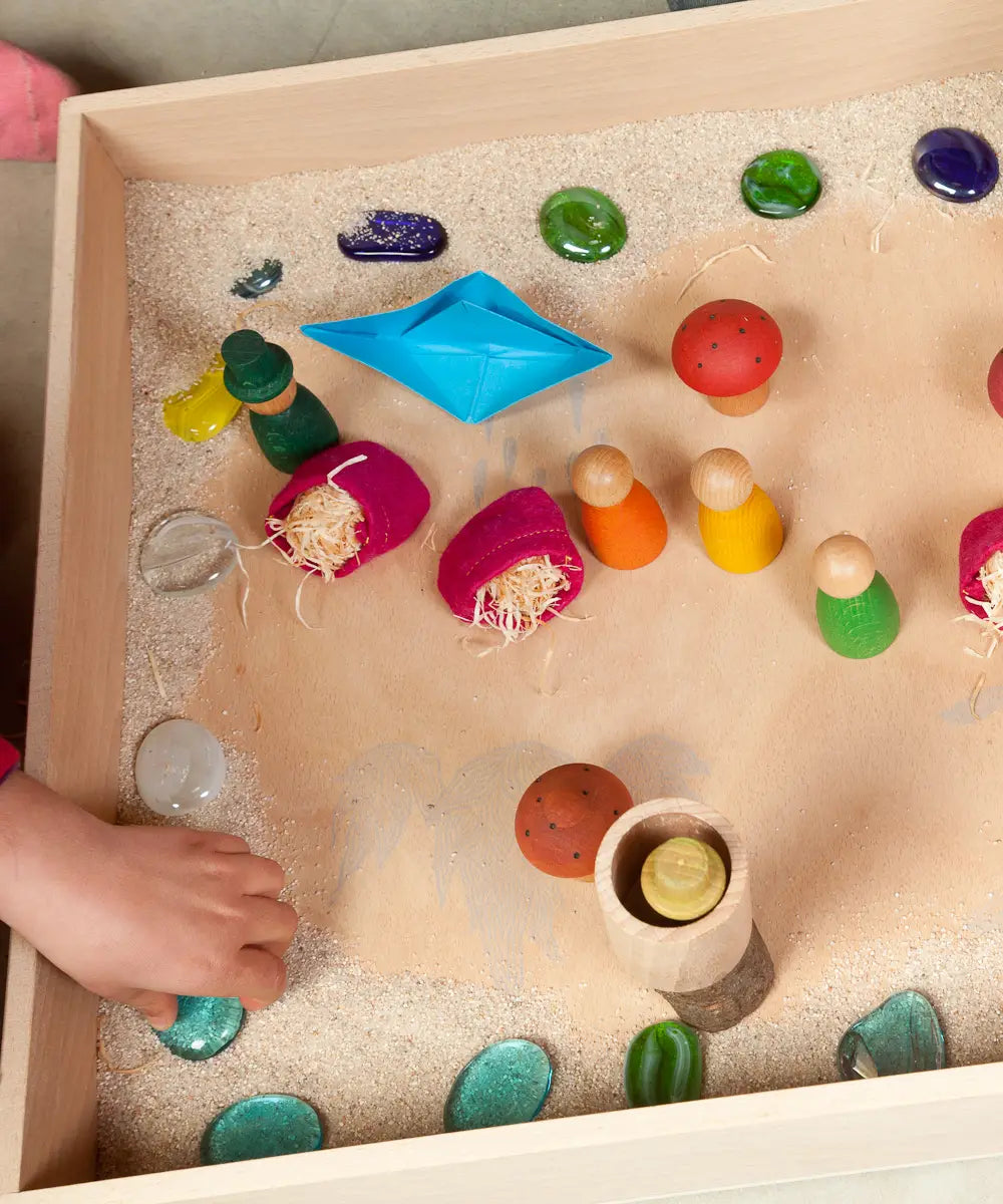 A sensory small world setup inside a Grapat wooden freeplay tray