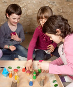 Children creating a small world using the Grapat freeplay tray, peg dolls and various small pieces