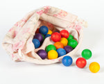 Grapat 36 Wooden Marbles, in six rainbow colours in a fabric storage bag. White background.