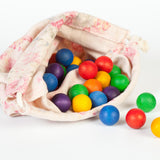 Grapat 36 Wooden Marbles, in six rainbow colours in a fabric storage bag. White background.