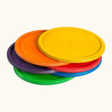 A stack of Grapat handcrafted wooden dishes in rainbow inspired colours