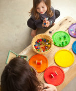 Children's creative play using the Grapat wooden rainbow dishes and various small items