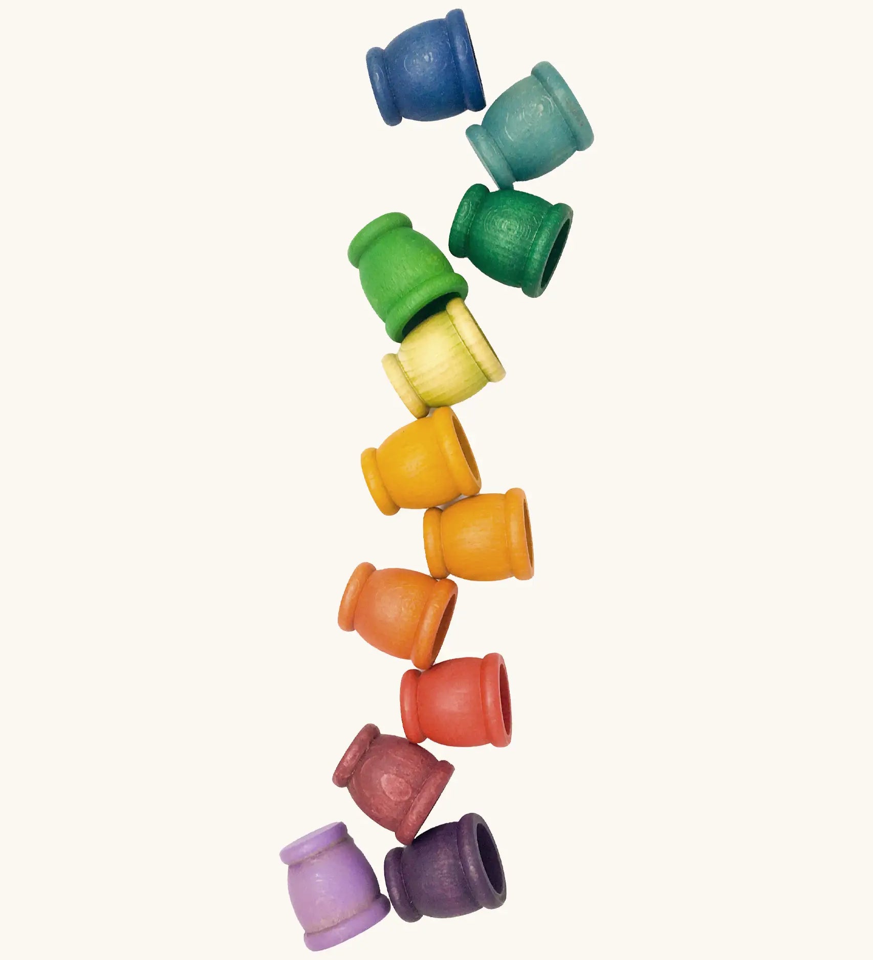 A set of 12 small handcrafted wooden Grapat curved cups in rainbow inspired colours